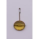 A large oval citrine brooch, in an unmarked yellow metal mount, 3.5 x 3cm.