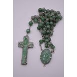 A carved jade and stone rosary bead necklace, 128cm.