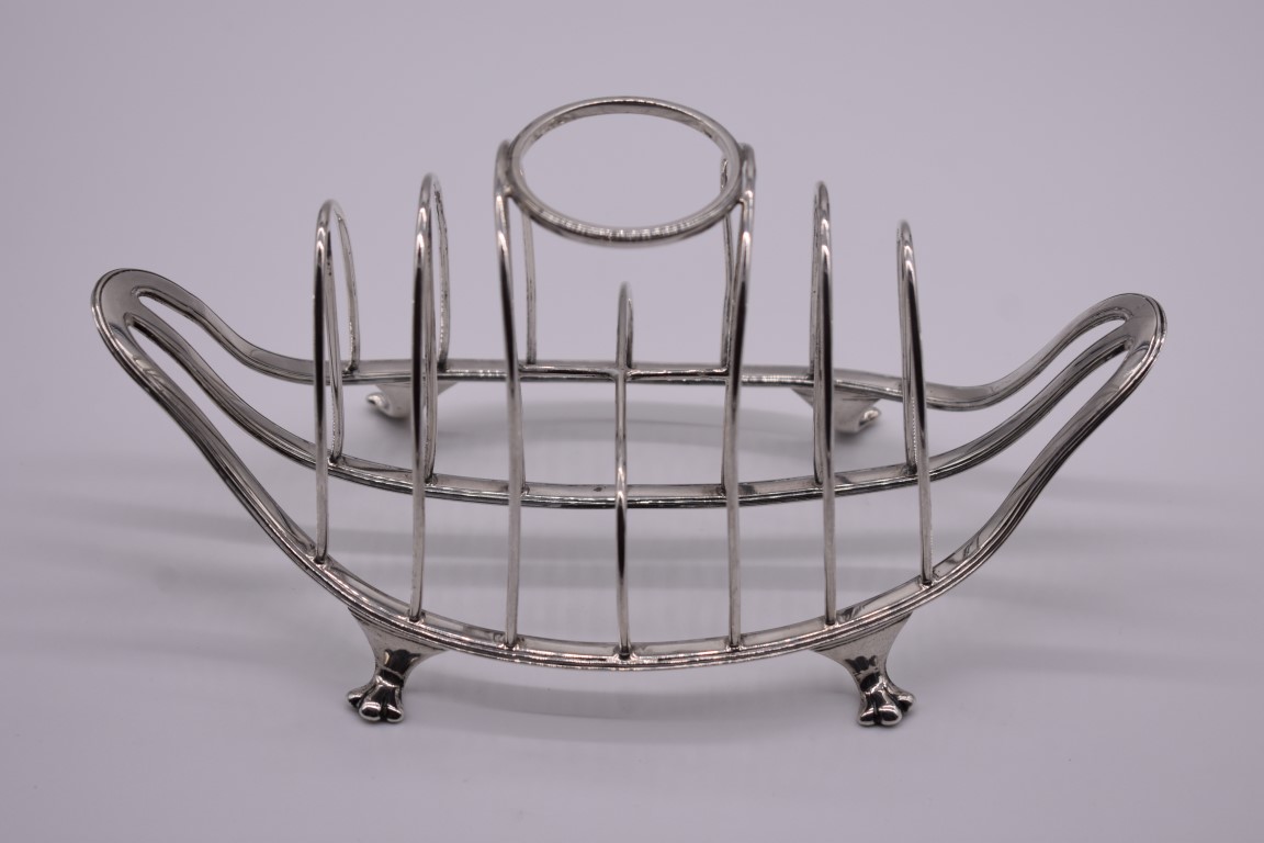 An unusual Edwardian silver combination egg holder and toast rack, by Thomas Bradbury & Sons Ltd,