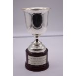 A continental white metal trophy cup, stamped 800, on wood socle, total height 23cm.