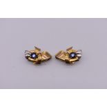 A pair of gold and sapphire ear clips, stamped 9k, 2cm.