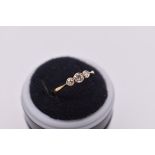 A gold and diamond three stone ring, stamped 18ct & Plat.