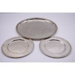 Two white metal dishes, stamped 900, both engraved presentation; together with a similar salver,