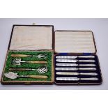 A cased French white metal and horn four piece serving set; together with a cased set of six