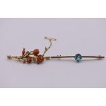 A floral carved coral brooch, attached to a gold pin stamped 9ct, 5cm; together with a blue topaz