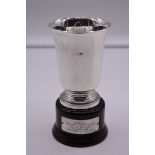 An Italian white metal trophy cup, by R Miracoli, stamped 800, on wood socle, 18cm total height.