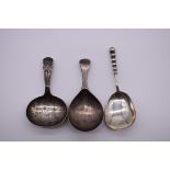 A George II bright cut silver caddy spoon, by John Hawkins, London 1820; together with two others,