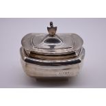 An Edwardian silver tea caddy, having lion and shield finial, probably by Jones & Crompton,
