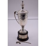 An Italian white metal twin handled trophy cup and cover, by R Miracoli, stamped 800, on wood socle,