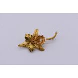 A brushed gold and pearl orchid brooch, stamped 18k, 3.9g total weight.