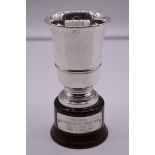 An Italian white metal trophy cup, by R Miracoli, stamped 800, on wood socle, 16.5cm total height.