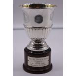An Italian white metal trophy cup, by R Miracoli, stamped 800, on wood socle, total height 18cm.
