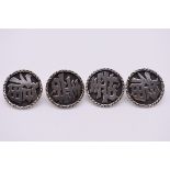 A set of four Chinese silver buttons, by Kwan Hu, decorated Chinese characters.