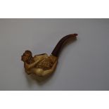 An old novelty meerschaum pipe, carved with a naked lady.