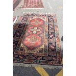 A Persian rug, having three crosses to central field, with floral borders, 188 x 120cm.