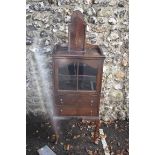 A 1930s oak display cabinet, 52cm wide; together with a candle box, 40cm high. This lot can only