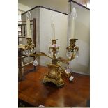 An antique cast and gilt brass three light table lamp, 43cm wide.