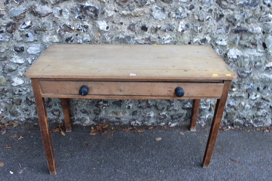 A Victorian mahogany tea table, 76cm wide; together with a rectangular pine table having one long