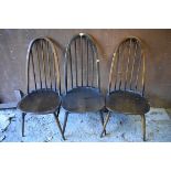 A set of three dark Ercol highback dining chairs. This lot can only be collected on Saturday 5th