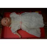 An Armand Marseille baby doll, (eyes loose in head).