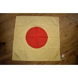A reproduction World War II Japanese Hinomaru 'Disk of the Sun' flag, approx 64cm square.