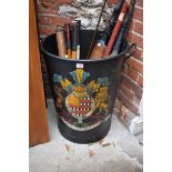 A large metal twin handled log bin or stick stand, emblazoned with a coat of arms, 62cm high x