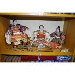 An interesting set of three Japanese porcelain Samurai dolls, each with finely made and