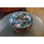 A Japanese cloisonne enamel circular box and cover, decorated with birds amongst flowers, 30.5cm