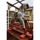An old painted wood rocking horse, 112cm high.