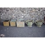 A pair of fibreglass garden urns; together with three other rectangular examples. This lot can