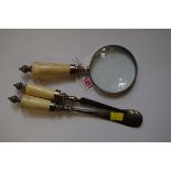 A gentleman's three piece bone handled and electroplated desk set, comprising: a magnifying glass,