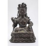 A Chinese bronze figure of Guanyin, Ming four character mark to back, 15.5cm high.