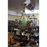 An antique brass ceiling light, with scroll decoration, total drop 60cm.
