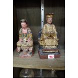 A Chinese carved and painted wood figure of an Emperor, Qing, 21.5cm high; together with a similar