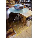 A modern glass and chrome bar table, 65cm diameter.