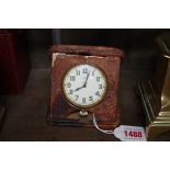An early 20th century Asprey 8 day travel timepiece, in snakeskin folding case, 10.5cm wide.