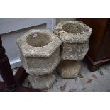 A pair of composition stone hexagonal pedestal planters, 53cm high.