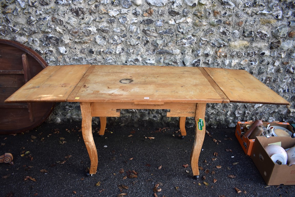 A continental pine drawleaf table, 198.5cm extended, 81cm wide. This lot can only be collected on