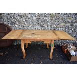 A continental pine drawleaf table, 198.5cm extended, 81cm wide. This lot can only be collected on