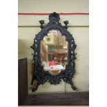 A 19th century cast and patinated brass easel back mirror, 49cm high. (a.f.)