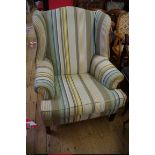 A reproduction wing armchair.