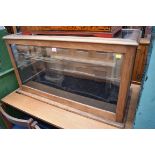 An early 20th century mahogany museum display case, with glazed top, 56cm high x 145cm wide x 49.5cm