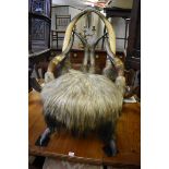 Taxidermy: a novelty buffalo horn and hide chair, 86.5cm high.