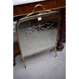 A brass and mirrored glass fire screen, 47.5cm wide.
