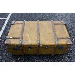 A wood bound travelling trunk, containing an Eastern prayer mat and three umbrellas. This lot can