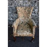 An early 20th century buttonback armchair having stained beech legs. This lot can only be