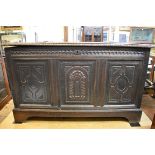 An antique carved oak panel coffer, with provenance to interior of lid, 111cm wide.