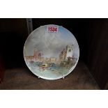 A late 19th century porcelain plate, painted with a view of Pavia, Italy, indistinctly signed,