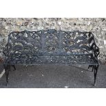 A black painted steel garden bench decorated stylised ferns and floral scrolls, 153cm wide. This lot