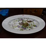 A Continental porcelain oval platter, painted and printed with nesting goldfinches, 51cm wide.